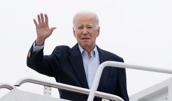 President Joe Biden waving as he boards Air Force One