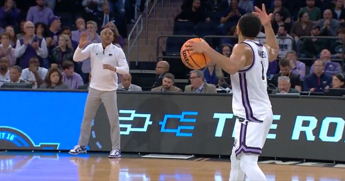 Kansas State guard Markquis Nowell exchanges animated hand signals with his coach, Jerome Tang, during the Wildcats' NCAA Tournament game against Michigan State.
