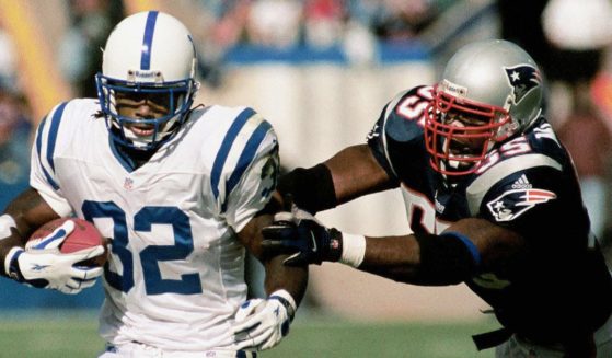 New England Patriots' Willie McGinest, right, tries to take down Indianapolis Colts' running back Edgerrin James, left, in a file photo from October, 2000.