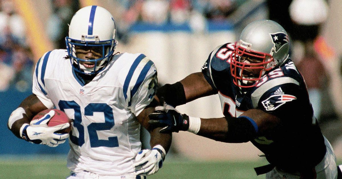 New England Patriots' Willie McGinest, right, tries to take down Indianapolis Colts' running back Edgerrin James, left, in a file photo from October, 2000.