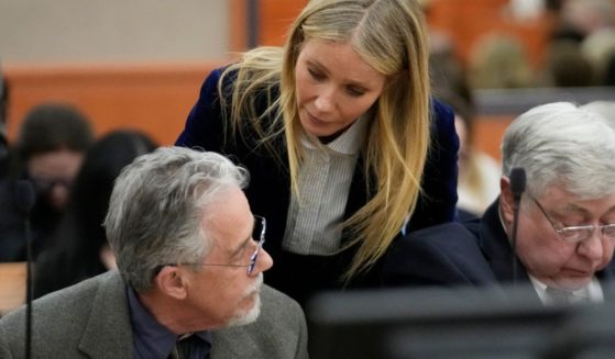 Actress Gwyneth Paltrow leans in to speak to retired optometrist Terry Sanderson after the verdict was read Thursday in his $300,000 lawsuit against her over a 2016 skiing accident in Park City, Utah.