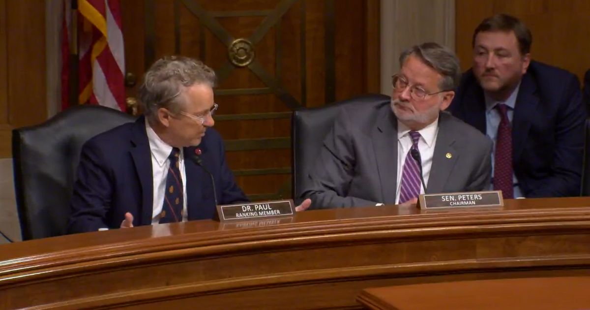 Republican Sen. Rand Paul of Kentucky, left, talks to Democratic Sen. Gary Peters of Michigan during a meeting of the Senate Homeland Security Committee on Wednesday.