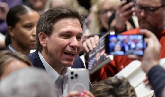 Florida Gov. Ron DeSantis greets people in the crowd during an event Friday, March 10, 2023, in Davenport, Iowa. (Ron Johnson / Associated Press)