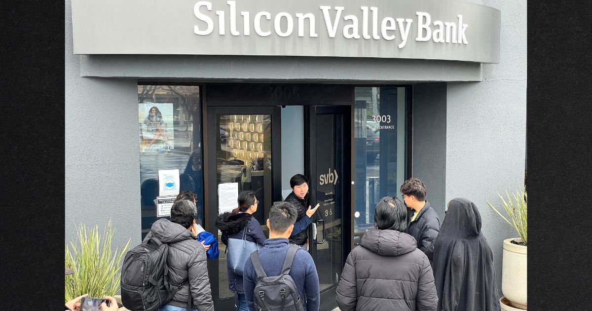 A worker, center, tells customers Friday that the Silicon Valley Bank in Santa Clara, California, is closed. The bank was shut down on Friday morning by California regulators and was put in control of the Federal Deposit Insurance Corporation.
