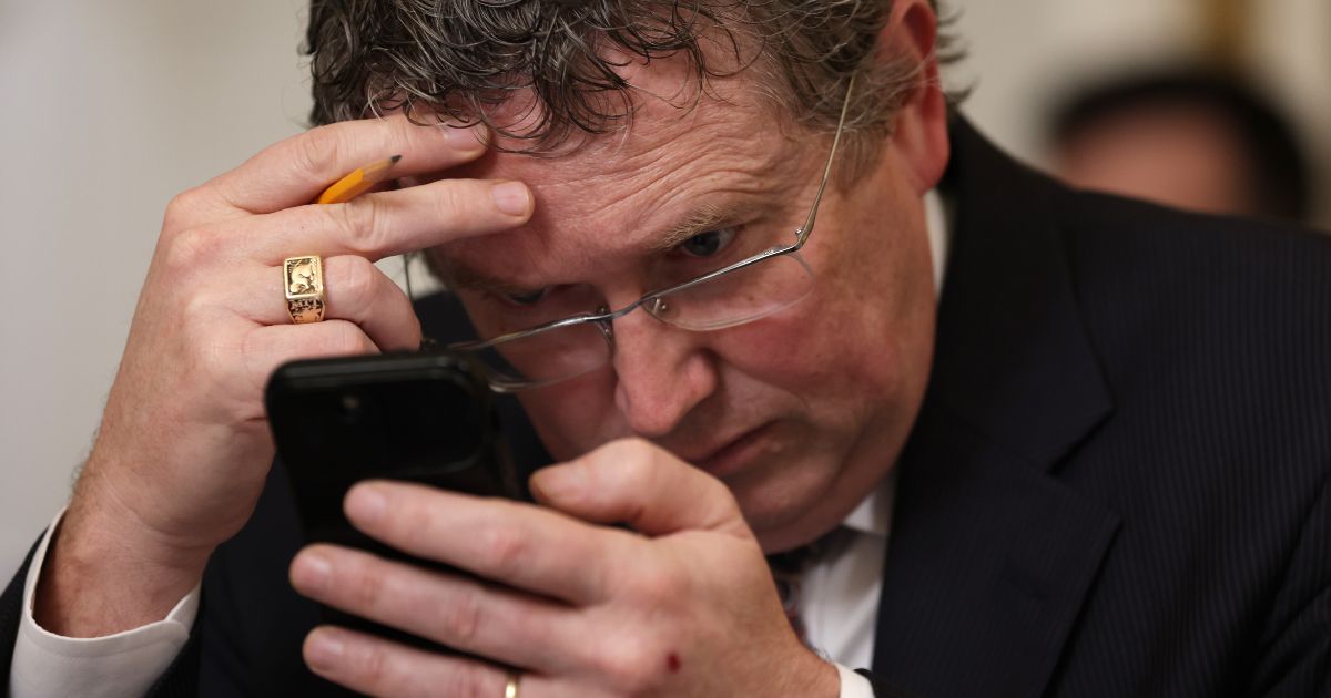Rep. Thomas Massie looks at his phone during a House Committee on Rules in Washington, D.C., on Jan. 31.