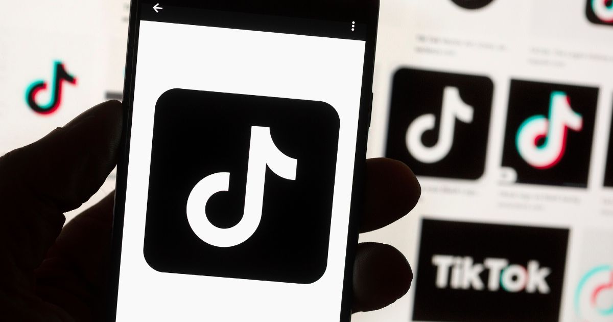 The TikTok logo is seen on a cellphone on Oct. 14, 2022, in Boston. China’s government said Thursday, March 23, 2023, it would oppose possible U.S. plans to force TikTok’s Chinese owner to sell the short-video service as a security risk and warned such a move would hurt investor confidence in the United States.(Michael Dwyer / Associated Press)