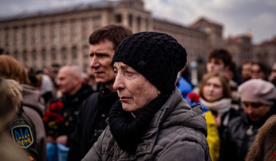 People attend a ceremony for slain Ukrainian volunteers in Kyiv on Tuesday.