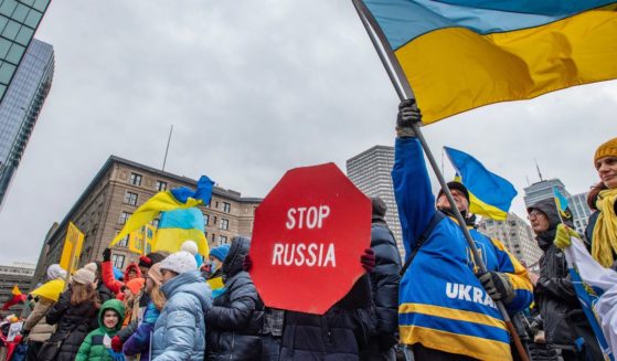 Supporters of Ukraine hold signs and wave flags during a rally in Boston on Sunday.