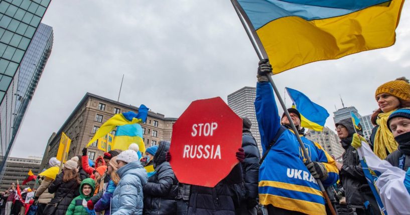 Supporters of Ukraine hold signs and wave flags during a rally in Boston on Sunday.