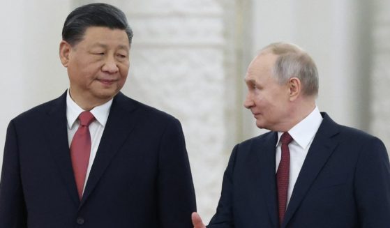 Chinese President Xi Jinping, left, talks with Russian President Vladimir Putin, right, in Moscow on Tuesday.