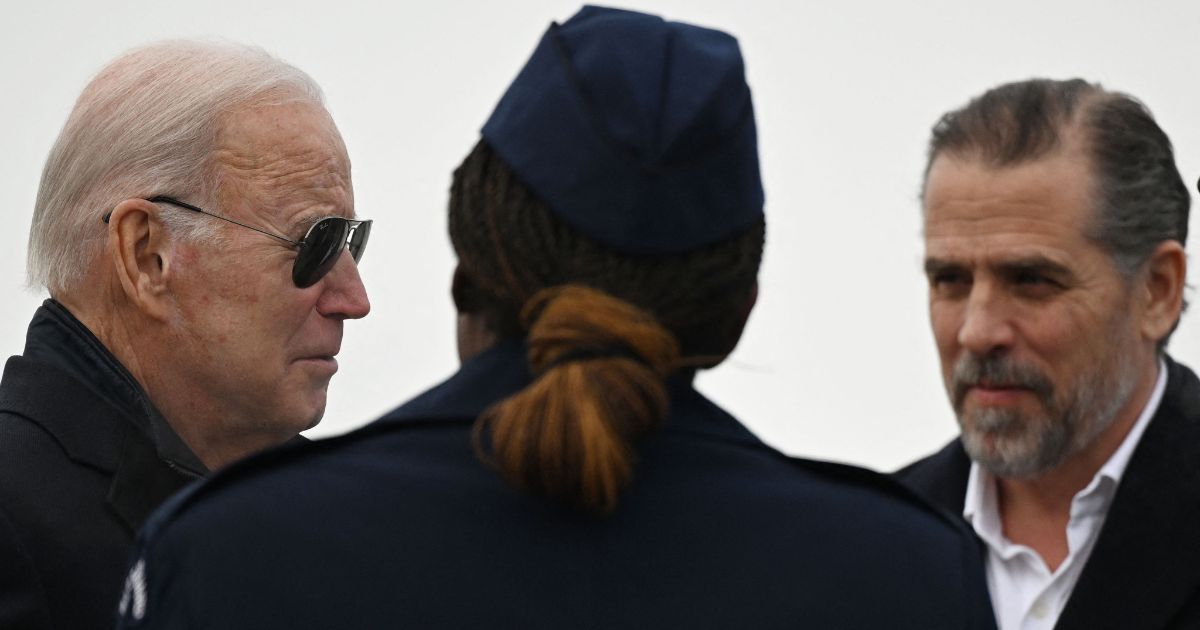 President Joe Biden, with son Hunter Biden (R), speaks with Chief Master Sergeant Sonja Williams on arrival at Hancock Field Air National Guard Base in Syracuse, New York, on Feb. 4.