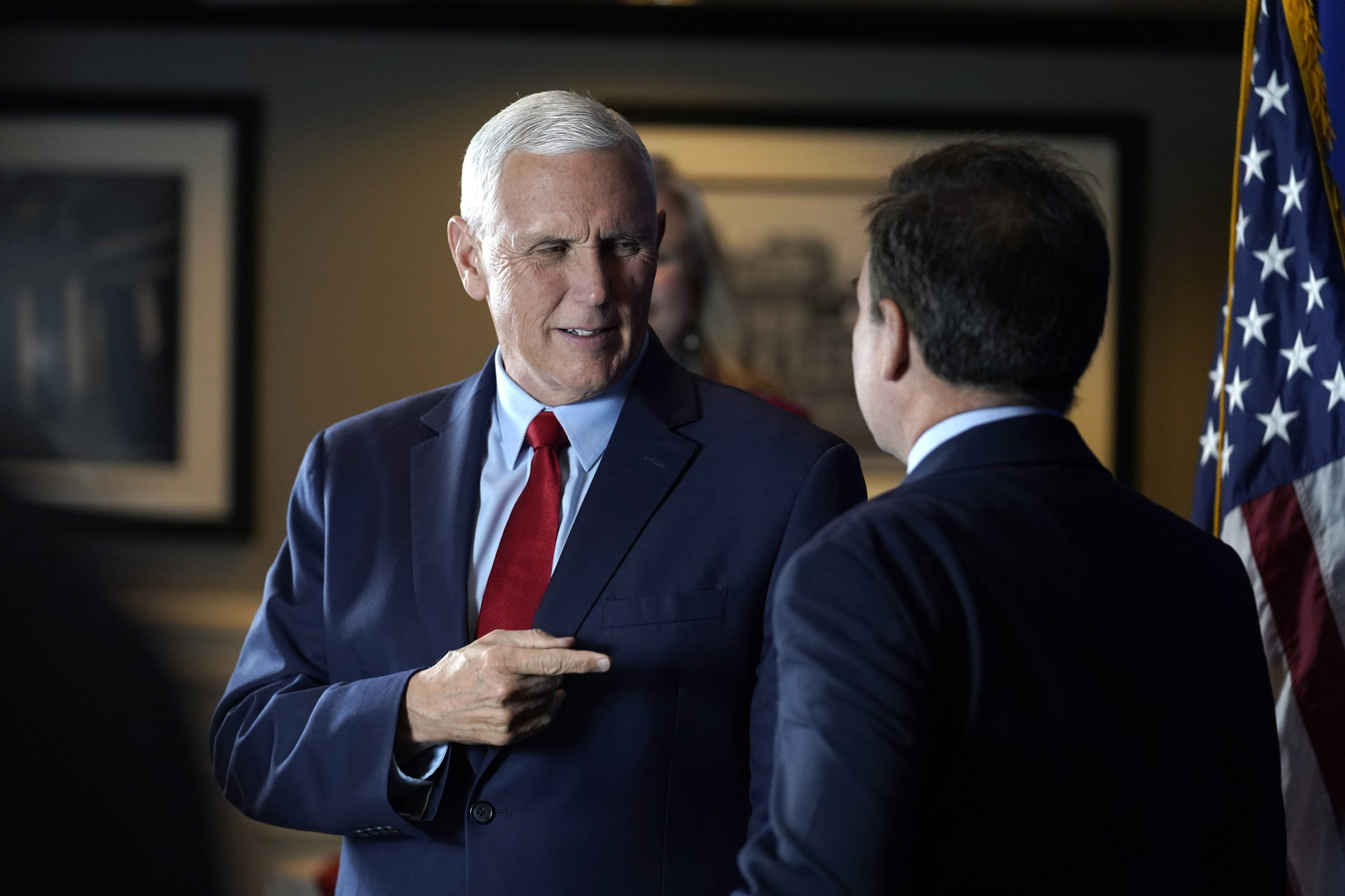 Former Vice President Mike Pence greets people while signing copies of his book "So Help Me God" before the start of a GOP fundraising dinner on Thursday in Keene, New Hampshire.