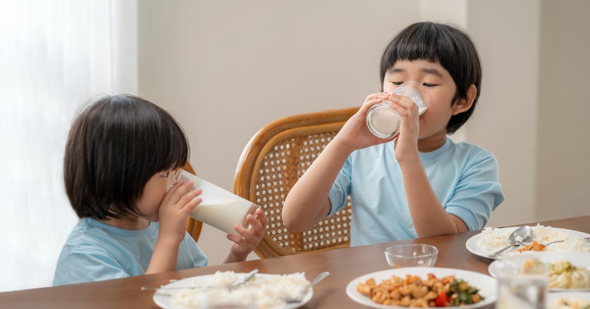 children drinking milk at a table
