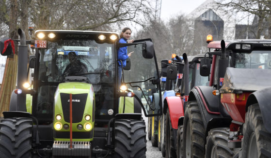 Belgian farmers block traffic with their tractors on a road in the center of Brussels during a demonstration Friday. Hundreds of tractors were driven there by angry farmers protesting a plan to cut nitrate levels.