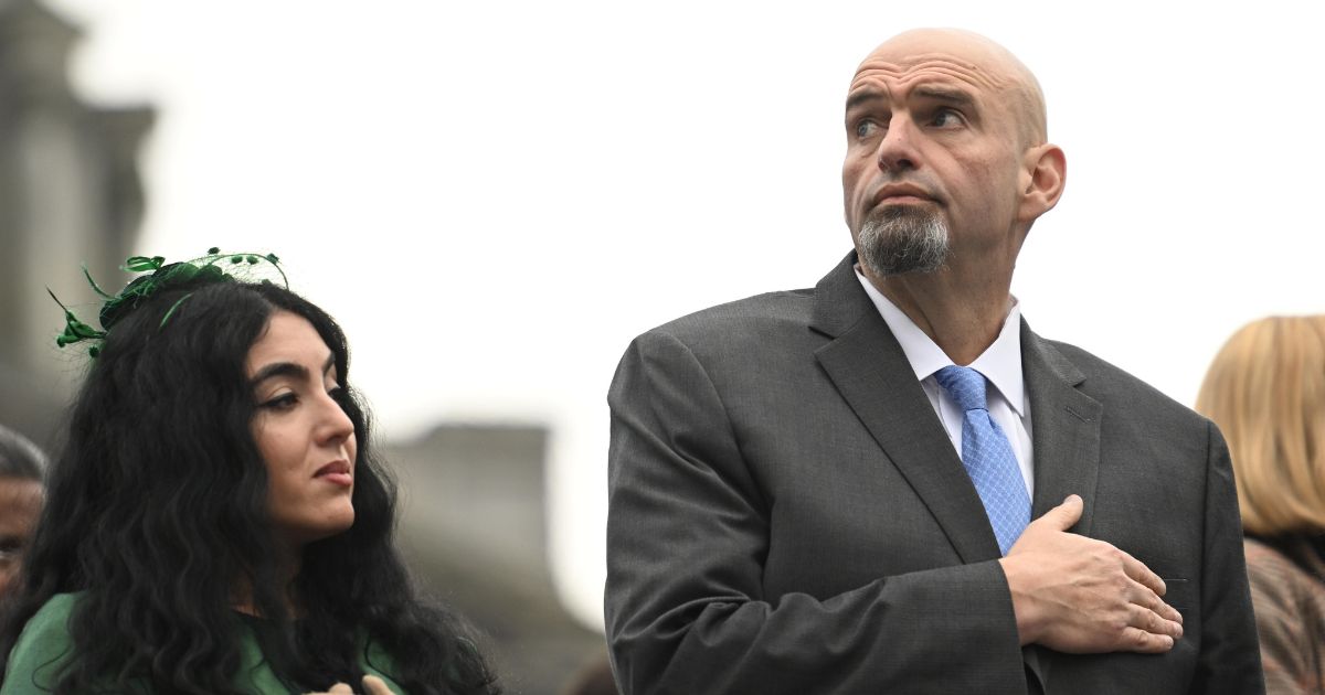 Senator John Fetterman (D-PA) and his wife, Gisele Barreto Fetterman, stand during the singing of the National Anthem before Josh Shapiro is sworn in as governor of Pennsylvania at the State Capitol Building on Jan. 17 in Harrisburg, Pennsylvania.