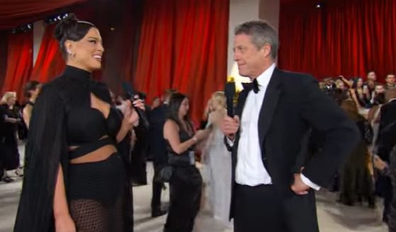 Actor Hugh Grant is interviewed by model Ashley Graham at the Oscars on Sunday.
