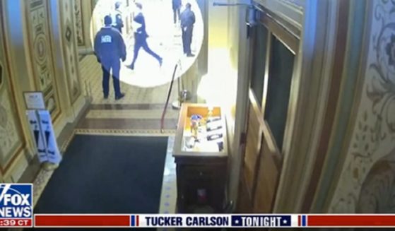 A video still has a spotlight on Missouri Sen. Josh Hawley running in a Capitol hallway on Jan. 6, 2021.