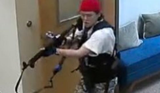 A woman identified as Audrey Hale stalks the Covenant School with a rifle on Monday in Nashville, Tennessee.