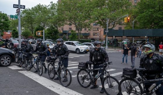 New York Police Department officers, who used bicycles to pen in protesters in the Bronx on June 4, 2020, prepare to make arrests for breaking curfew during an incident that led to a huge settlement against the city on behalf of those arrested.
