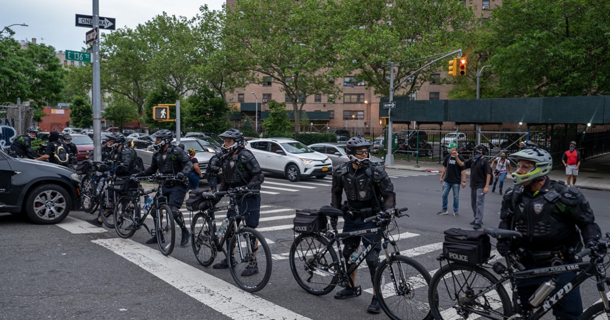 New York Police Department officers, who used bicycles to pen in protesters in the Bronx on June 4, 2020, prepare to make arrests for breaking curfew during an incident that led to a huge settlement against the city on behalf of those arrested.