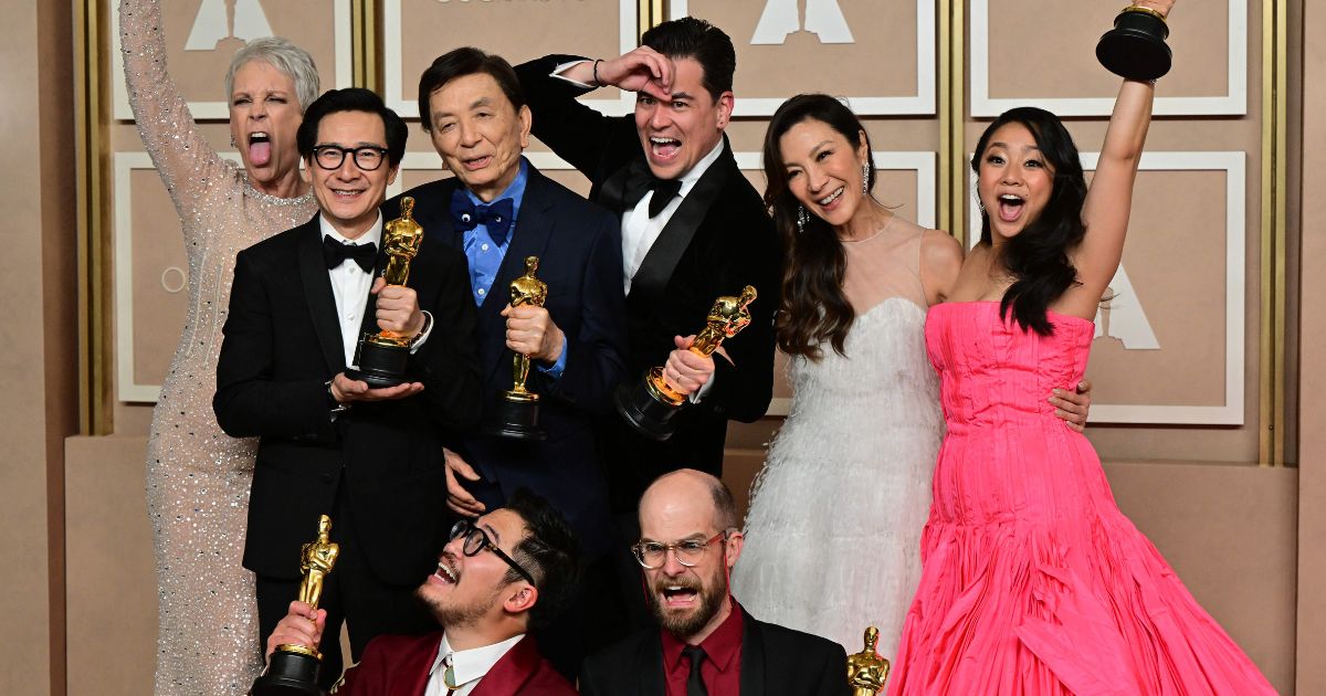 The cast and crew of "Everything Everywhere All at Once" Jamie Lee Curtis, Ke Huy Quan, James Hong, Jonathan Wang, Michelle Yeoh, Stephanie Hsu, Daniel Kwan and Daniel Scheinert pose with their Oscar trophies in the press room during the 95th Annual Academy Awards at the Dolby Theatre in Hollywood, California, on Sunday.