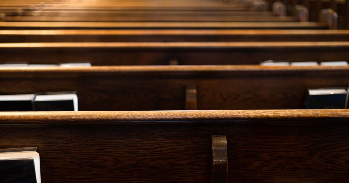 Church pews are seen in the above stock image.