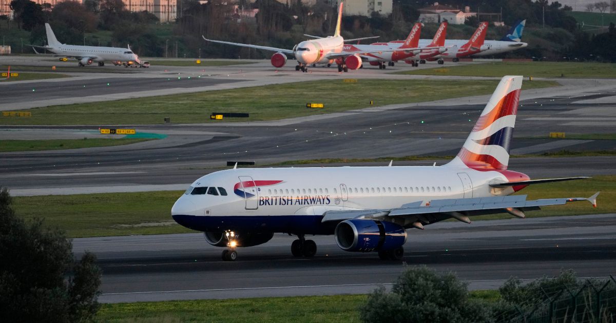 A British Airways passenger jet lands at the Lisbon airport on Jan. 25.