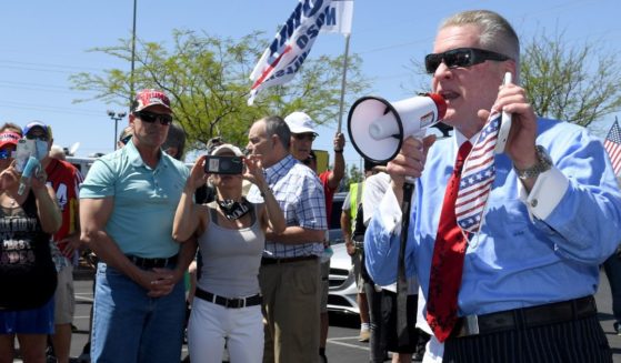 Conservative radio talk show host Wayne Allyn Root, right, speaks to supporters before hosting a protest caravan on the Las Vegas Strip to demand the reopening of the Nevada economy, hit hard by coronavirus-related closures, on April 24, 2020, in Las Vegas.