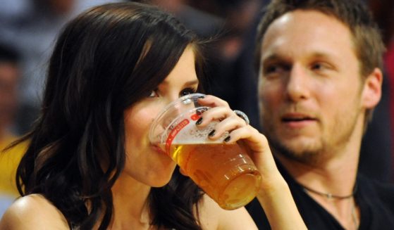 Actress Sophia Bush drinks from a glass of beer as she watches the Los Angeles Lakers play Orlando Magic players during game one of the NBA finals at the Staples Center in Los Angeles on June 4, 2009.
