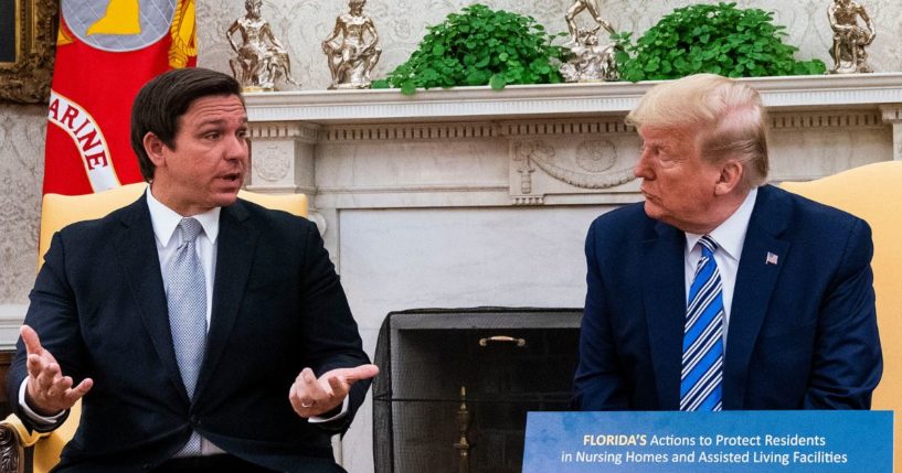 Florida Gov. Ron DeSantis, left, speaks while meeting with then President Donald Trump on April 28, 2020, in Washington, D.C.