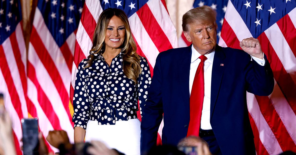 Former President Donald Trump, joined by former first lady Melania Trump, arrives to speak at the Mar-a-Lago Club in Palm Beach, Florida, on Nov. 15, 2022.
