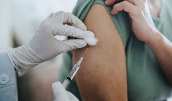 A woman receives a vaccine in this stock image.