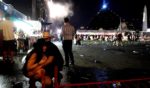 People take cover at the Route 91 Harvest country music festival after apparent gun fire was heard on Oct. 1, 2017, in Las Vegas.