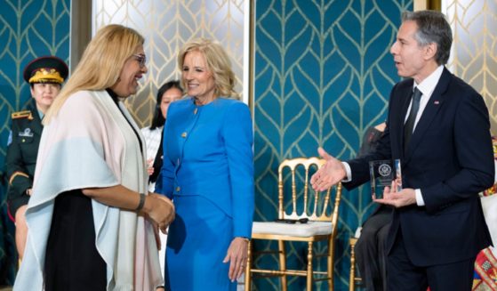 Alba Rueda, an Argentine man who "identifies" as a "woman," receives the International Women of Courage Award from first lady Jill Biden and State Antony Blinken during a ceremony Wednesday in the East Room of the White House to commemorate International Women's Day.