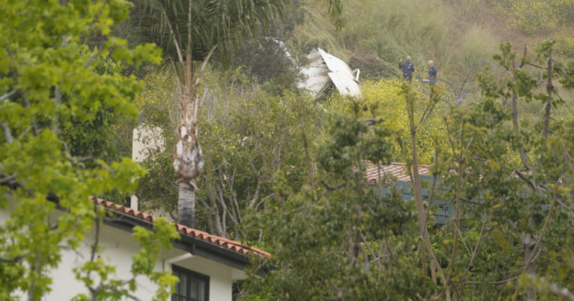 National Transportation Safety Board investigators inspecting a downed plane.