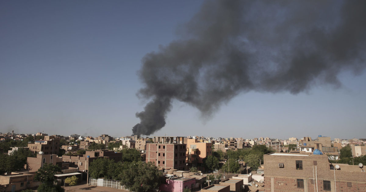 black smoke rising over Khartoum, Sudan