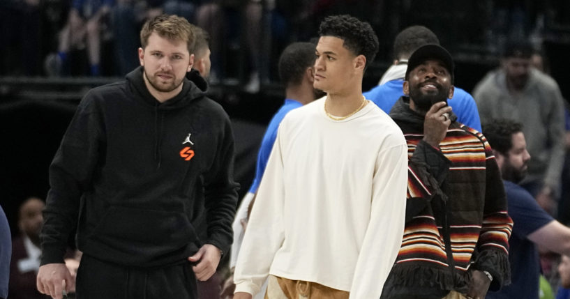 Dallas Mavericks' Luka Doncic, left, Josh Green, center, and Kyrie Irving, right, stand on the court during a timeout in the second half of an NBA basketball game against the Chicago Bulls, Friday, April 7, 2023, in Dallas.