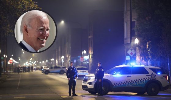 Police investigate the scene of a mass shooting on Oct. 31, 2022, in Chicago. President Joe Biden smiles on the South Lawn of the White House on Monday in Washington, D.C.