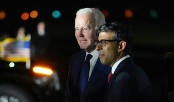 President Joe Biden walks with British Prime Minister Rishi Sunak after arriving on Air Force One at Belfast International Airport in Belfast, Northern Ireland, on Tuesday.