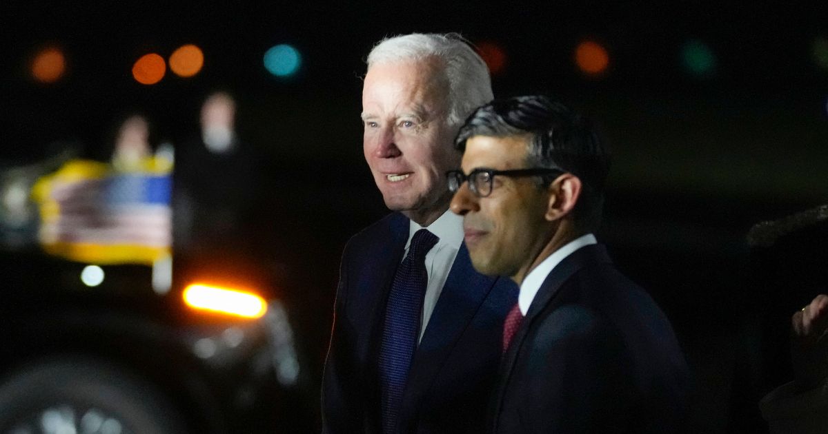 President Joe Biden walks with British Prime Minister Rishi Sunak after arriving on Air Force One at Belfast International Airport in Belfast, Northern Ireland, on Tuesday.