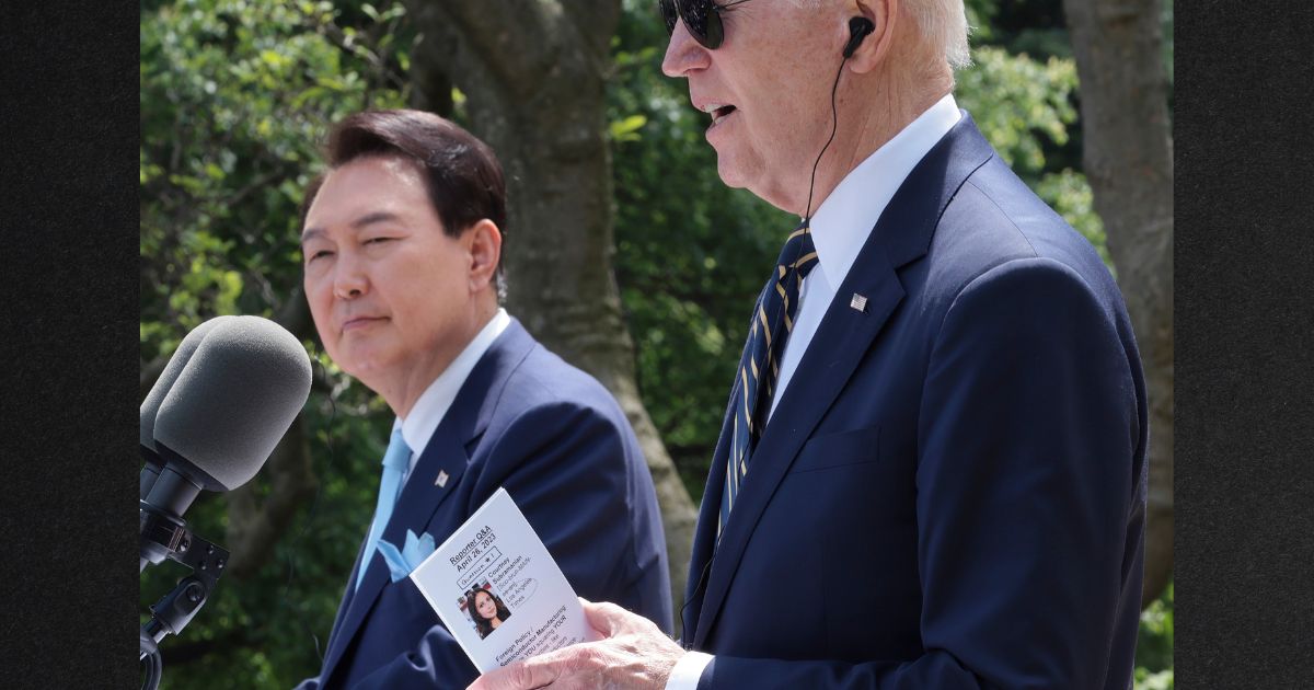 President Joe Biden looks at a note card referencing a reporter as he delivers remarks during a joint press conference with South Korean President Yoon Suk-yeol, left, at the White House, Wednesday.