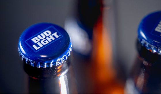 Caps on bottles of Bud Light beer are seen in a stock photo.
