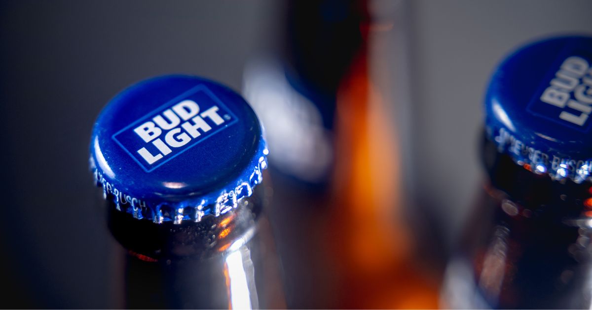 Caps on bottles of Bud Light beer are seen in a stock photo.
