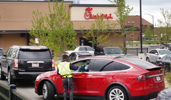 A worker takes orders from customers at a Chick-fil-A drive-thru lane in Chicago, Illinois, on May 6, 2021.