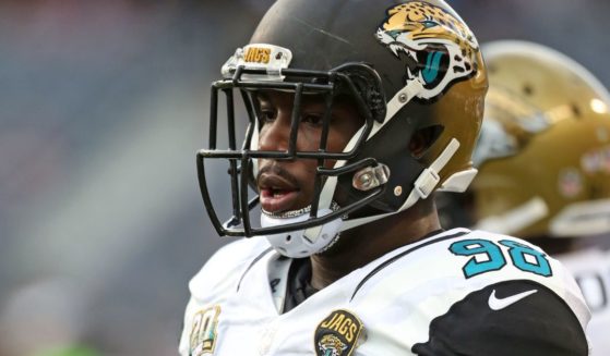 Chris Smith warms up prior to the Jacksonville Jaguars' preseason game against the Chicago Bears at Soldier Field on Aug. 14, 2014. Smith died Monday at age 31.