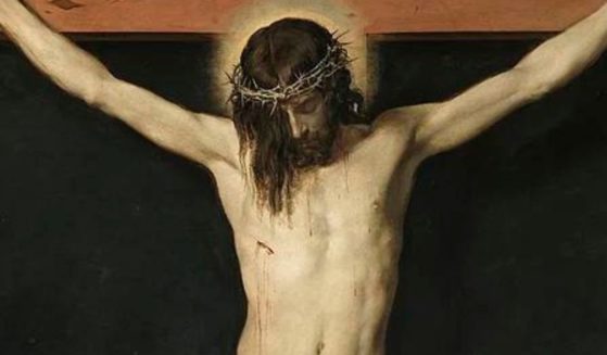 A painting of Christ crucified is seen above.