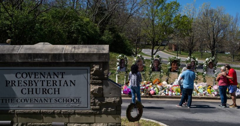 People visit a makeshift memorial at the entrance of The Covenant School on Saturday in Nashville, Tennessee.
