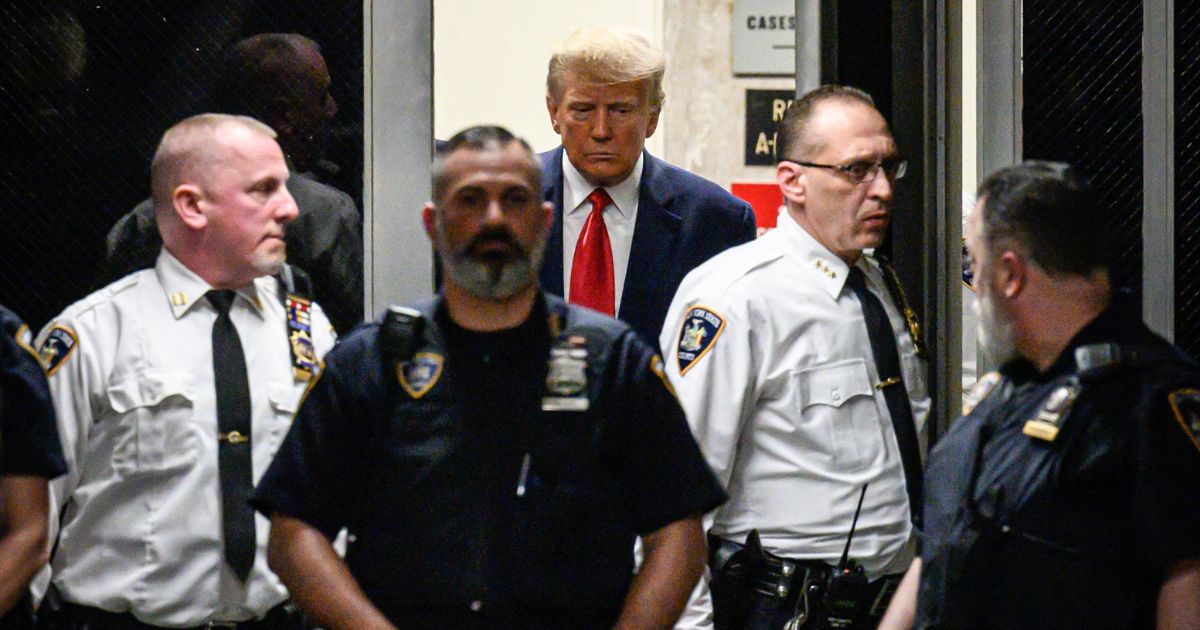 Former President Donald Trump walks to the courtroom at the Manhattan Criminal Court building in New York on Tuesday.