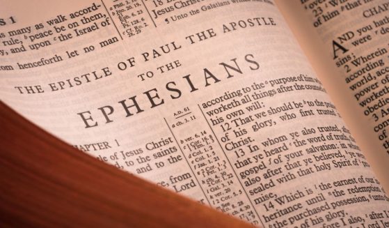 A Bible lays open to the book of Ephesians in the above stock image.