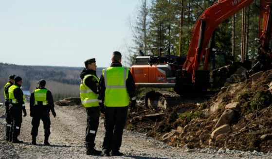 Finnish border guards work at the site of the construction of a border fence between Finland and Russia in Imatra, southeastern Finland, on Friday.